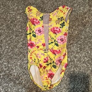 Beautiful, yellow flowered leotard with pink mesh panels in the center and back